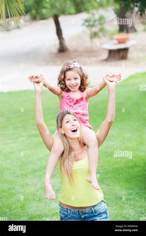 Mother Carrying Daughter On Shoulders Stock Photo Alamy