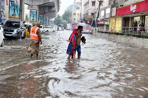 Vehicles Plying Through Flooded Road In Hyderabad Photogallery