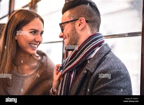 Happy Couple Laughing While Looking Each Other In The Bus Young