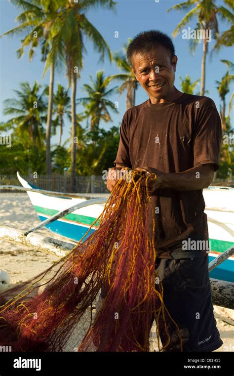 Fisherman Mending A Net Hi Res Stock Photography And Images Alamy