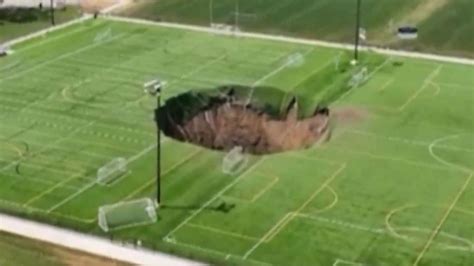 Watch Horror Moment Football Pitch Collapses As Foot Sinkhole