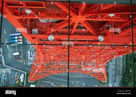 The View Down To The Vermilion Lattice Metal Construction Of The Tokyo Tower Through The Glass