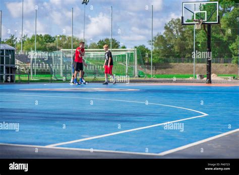 Abstract Blurry Background Of Boys Playing Basketball In Outdoor