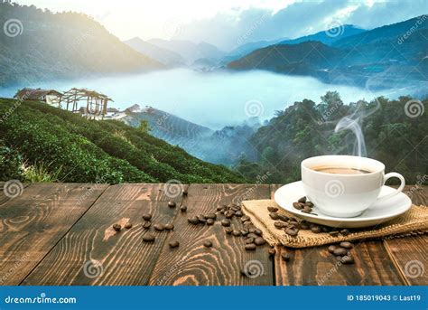 Morning Cup of Coffee and Coffee Beans with Mountain Background at Sunrise. Beauty Mountain ...