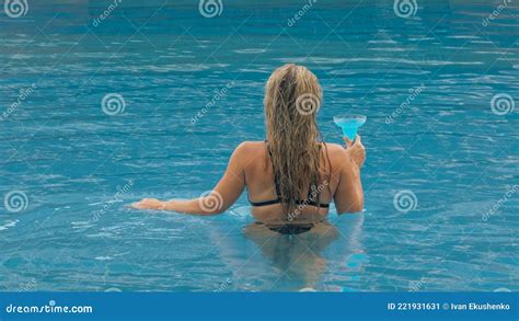 The Wide Middle Shot Pretty Woman Drinking Blue Cocktail Alcohol Liquor In Swimming Pool At