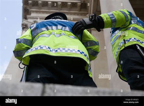 Two Police Officers Stand Guard During Protests In City Of London