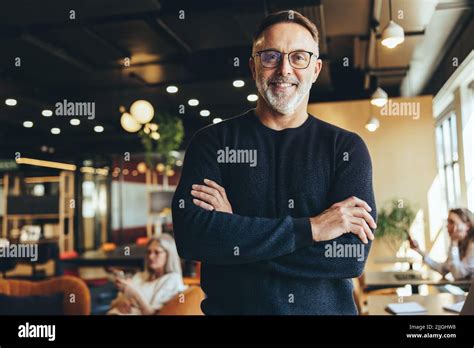 Mature Businessman Standing In A Co Working Space Happy Mature