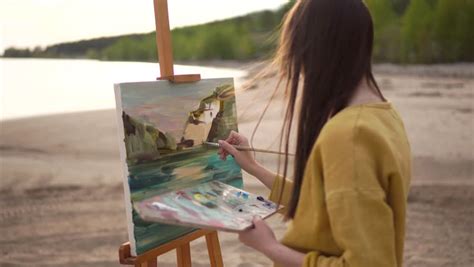 Young Woman Is Painting On Easel On The Bank Of The Sea Stock Footage Video 26209439 | Shutterstock