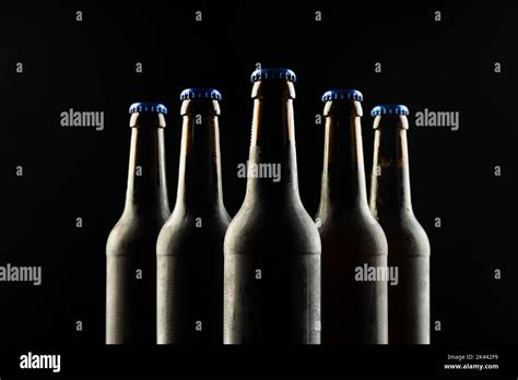 Image Of Five Beer Bottles With Blue Crown Caps With Copy Space On