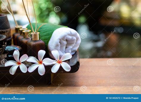 Thai Spa Composition Treatments Aroma Therapy With Candles And Plumeria Flowers On Wooden Table