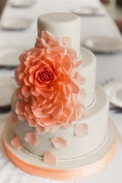 Three Tiered Luxury White Wedding Cake With Orange Flower Petals From