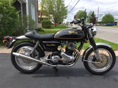 A Black And Gold Motorcycle Parked On The Street In Front Of A House