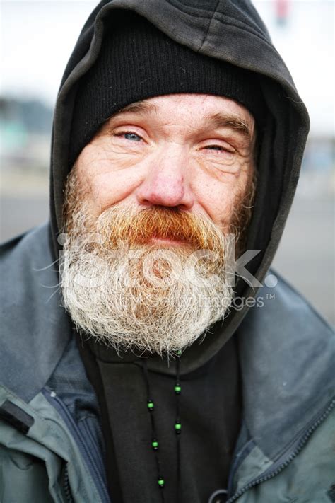 Homeless Man Bundeled Up In A Hat And Jacket Stock Photos