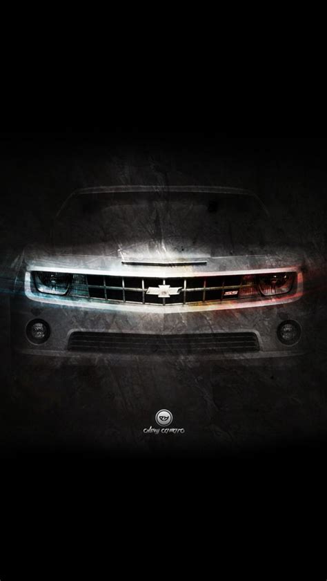 the front end of a silver car with lights on in the dark night, it ...