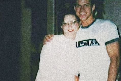 Two People Standing Next To Each Other In Front Of A Door With Their