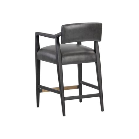 An Upholstered Black Leather Bar Stool With Arms And Back Rests Against