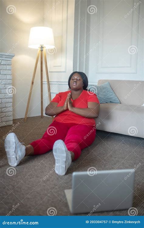 Plus Size African American Woman Meditating And Looking Relaxed Stock