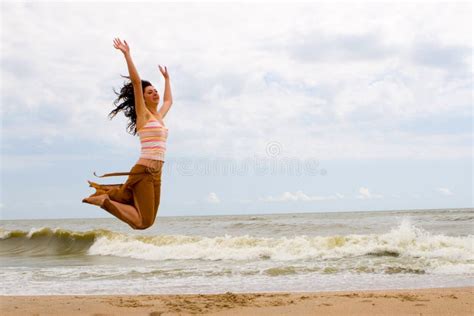 Silhouette Of Girl Jumping In Waves Of Ocean At S Stock Image Image