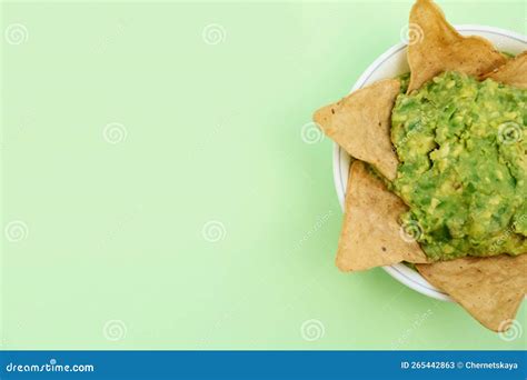 Delicious Guacamole Made Of Avocados With Nachos On Light Green