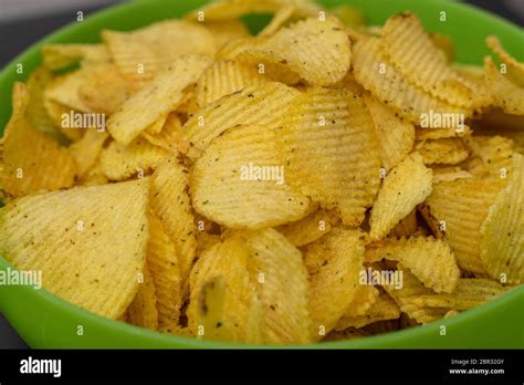 Crispy Potato Chips In A Green Cup Close Up Corrugated Potato Chips