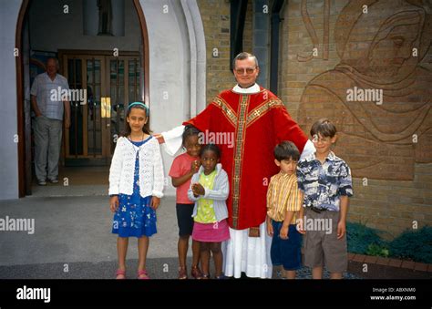 St Josephs Church Priest With Outstretched Hands Upwards And Children