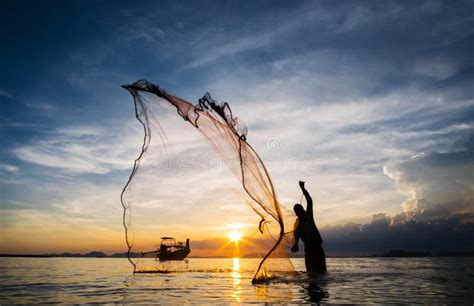 Silhouette of Fisherman Casting Fishing Net into the Sea Stock Image ...