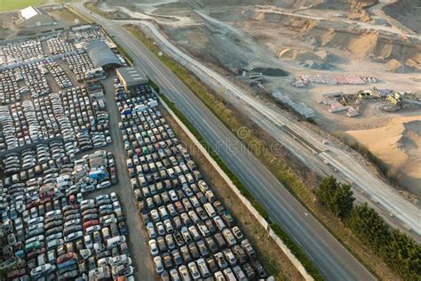 Aerial View Of Big Parking Lot Of Junkyard With Rows Of Discarded