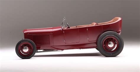 An Old Fashioned Red Car On A White Background