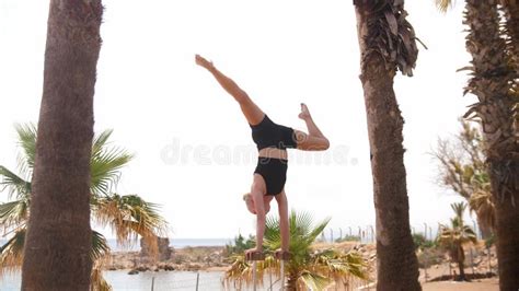 Gymnastique Au Bord De La Plage Une Jeune Femme Blonde Debout Sur Les Hautes Poutres Avec Ses