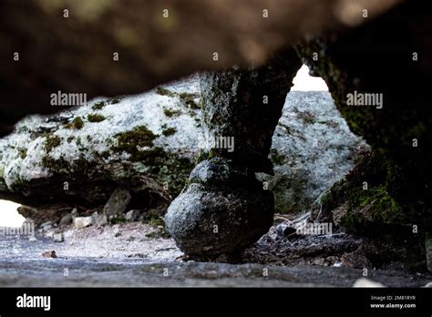 A peculiar round rock formation on the underside of a large boulder ...