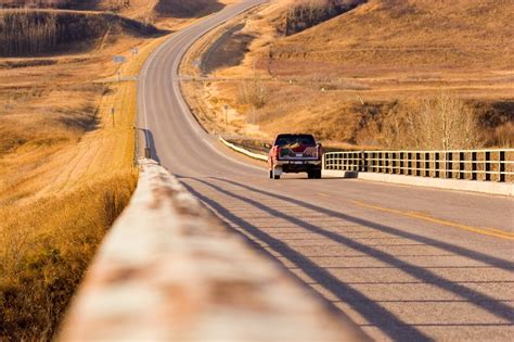 A Red Truck Driving On A Long Country Road Clean Power Marketing Group