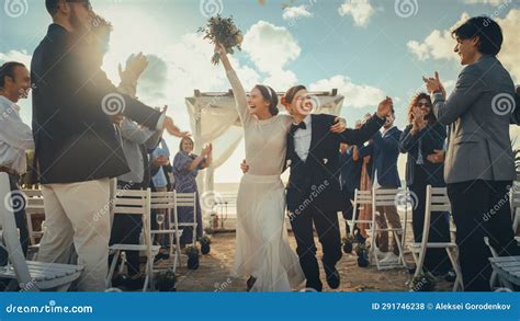 Attractive Female Couple Walking Up The Aisle At Outdoors Wedding