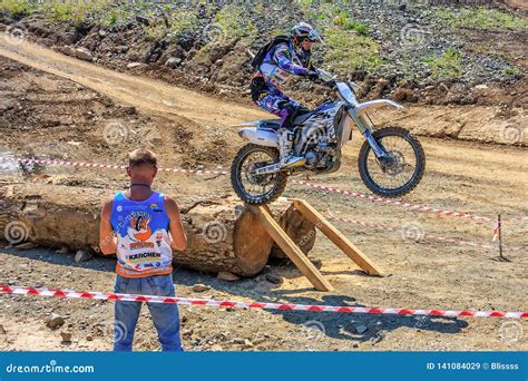 Enduro Motorbike Racer Overcomes Obstacle On Off Road Terrain Track At