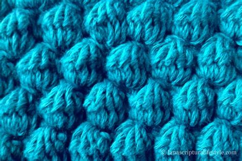 Close Up View Of The Texture Of A Crochet Blanket In Teal Blue