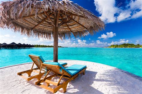 Two Chairs And Umbrella On Tropical Beach Stock Photo Mvaligursky