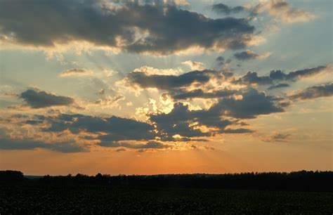 Premium Photo | Bright orange sunset covered by clouds fiery orange sunset sky