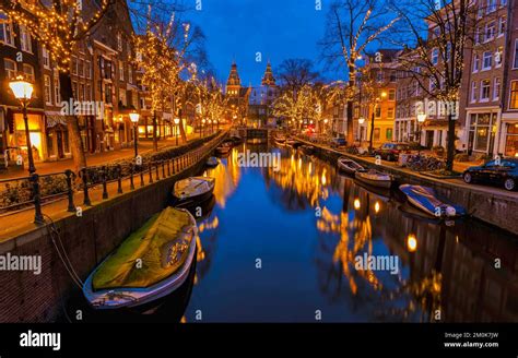 Christmas in Amsterdam canals with Christmas lights during December ...