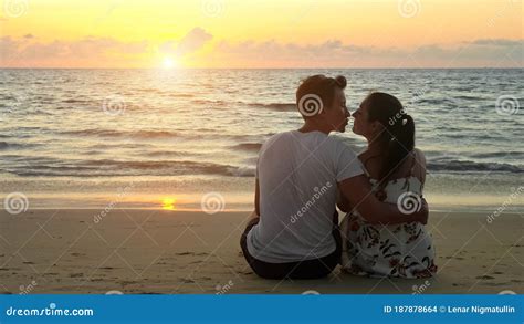 Lovely Young Couple Hugs and Kisses Sitting on Ocean Beach Stock Photo ...