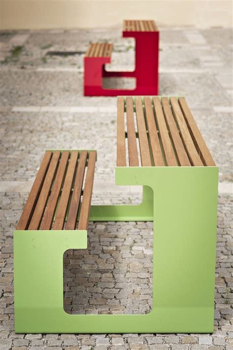 Two Wooden Benches Sitting Next To Each Other On Top Of A Stone Floor