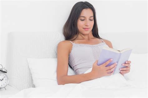 Premium Photo | Woman reading a book in bed