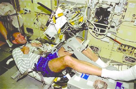 Astronaut Rick Linnehan Performing A Muscle Function Test Using The