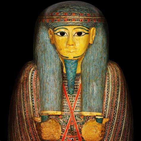 An Egyptian Statue Is Shown Against A Black Background