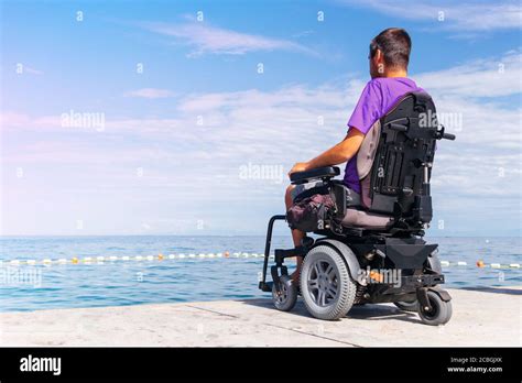 Man Sitting In A Wheelchair Looking At Sea Head And Spine Injury