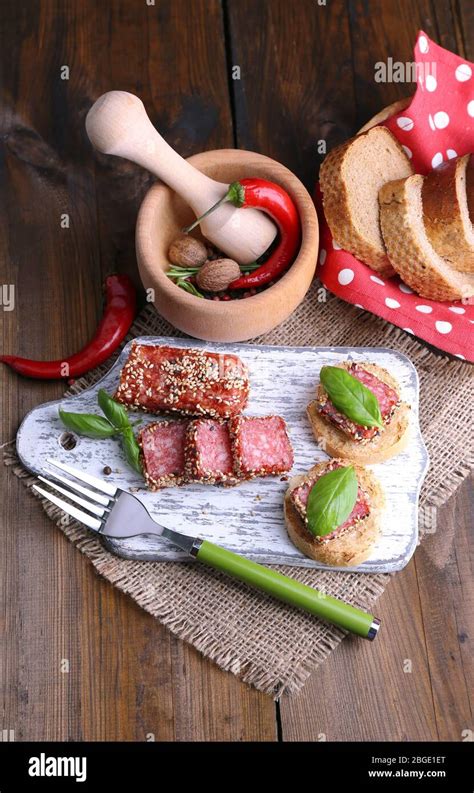 Composition With Knife Tasty Sandwiches With Salami Sausage Basil