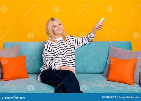 Photo Of Positive Retired Lady Sitting Comfy Divan Using Remote Control