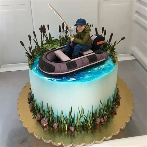 A Birthday Cake With A Man In A Boat On The Water And Grass Around It