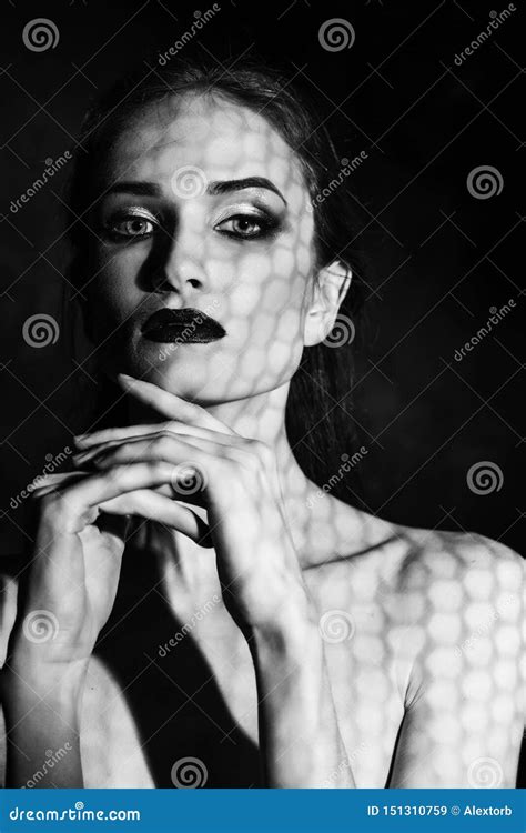 Beautiful Girl Model With Red Lips Make Up And Naked Shoulders Covered With A Shadow Mask In The