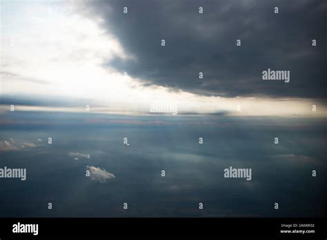 Looking Down Through Dramatic Clouds To Planet Earth Stock Photo Alamy