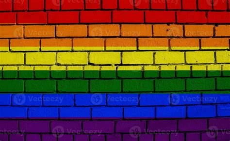 Flag Of The LGBT Community On The Background Of A Stone Wall Rainbow Symbol Of Gay Culture