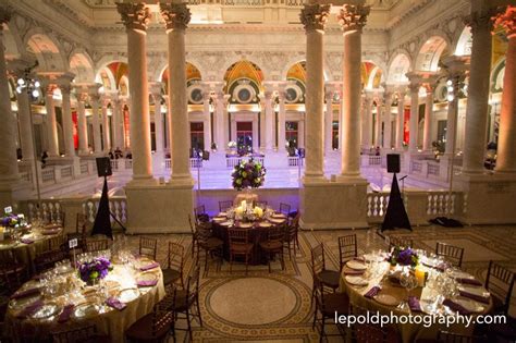 An Indoor Banquet Hall With Tables And Chairs Set Up For A Formal